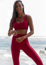 miljøvennlige treningsklær med resirkulert econyl i rød farget tights og sportsbh yoga topp
